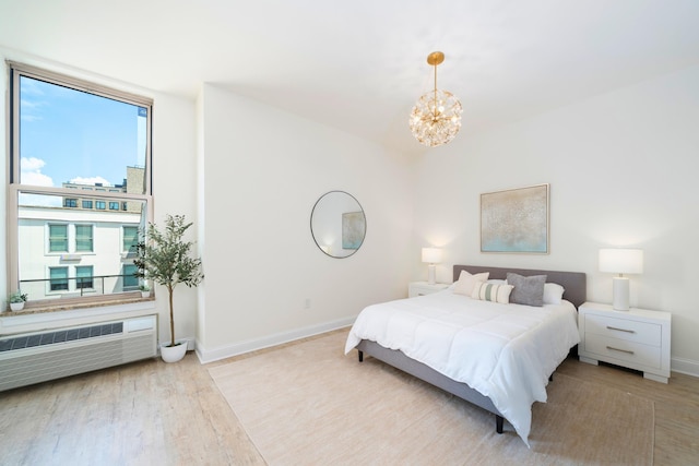 10 Regent St Unit 807, Jersey City, NJ 07302 - bedroom featuring a chandelier, radiator, and wood finished floors