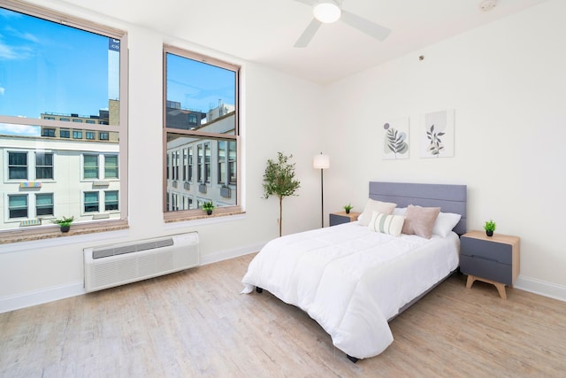 10 Regent St Unit 807, Jersey City, NJ 07302 - bedroom featuring wood finished floors, ceiling fan, and a wall mounted AC