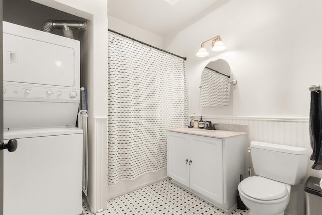 9 Coles St Unit 7, Jersey City, NJ 07302 - full bath with estacked washer and dryer, vanity, and a wainscoted wall