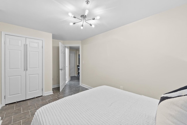 98 Bright St Unit 1G, Jersey City, NJ 07302 - bedroom featuring a chandelier, baseboards, and a closet