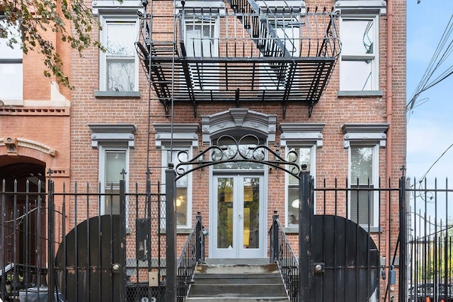 98 Bright St Unit 1G, Jersey City, NJ 07302 - view of front of home featuring french doors, a gate, and brick siding
