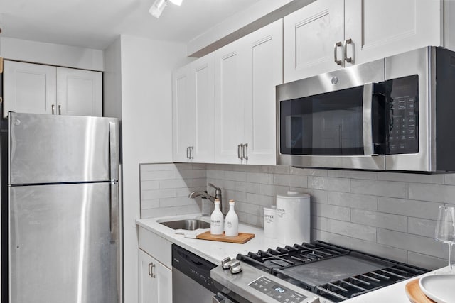 98 Bright St Unit 1G, Jersey City, NJ 07302 - kitchen with appliances with stainless steel finishes, white cabinetry, and decorative backsplash