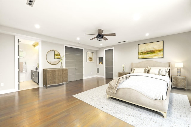 bedroom with ensuite bathroom, ceiling fan, and hardwood / wood-style flooring