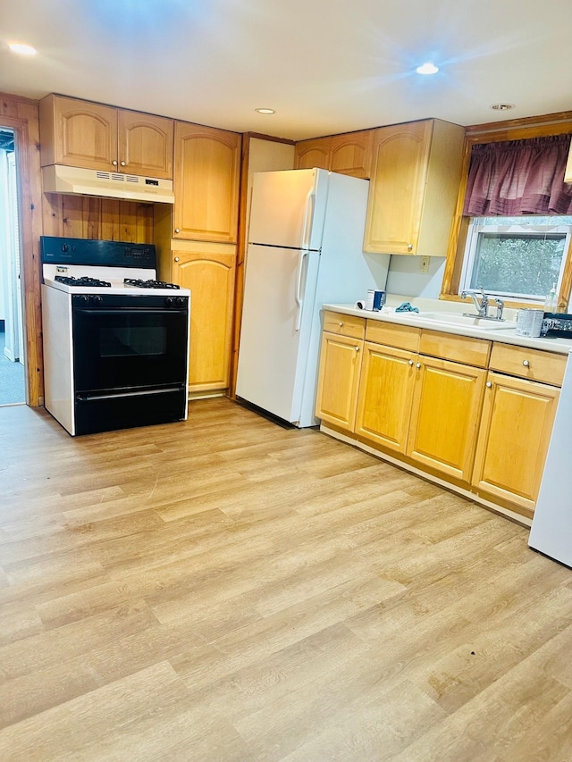 kitchen featuring gas range, white refrigerator, sink, and light hardwood / wood-style floors