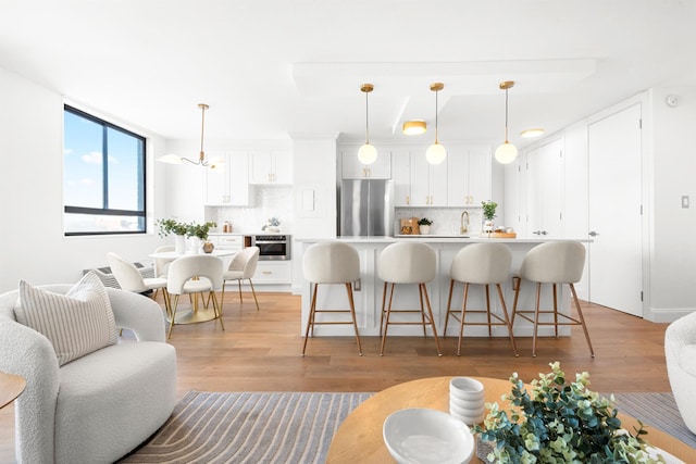 living room featuring light hardwood / wood-style floors and sink