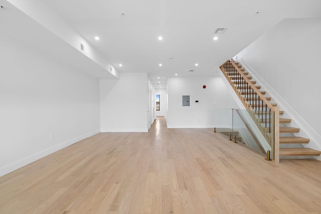 322 3rd St Unit D, Jersey City, NJ 07302 - unfurnished living room featuring recessed lighting, light wood-style floors, stairway, and electric panel