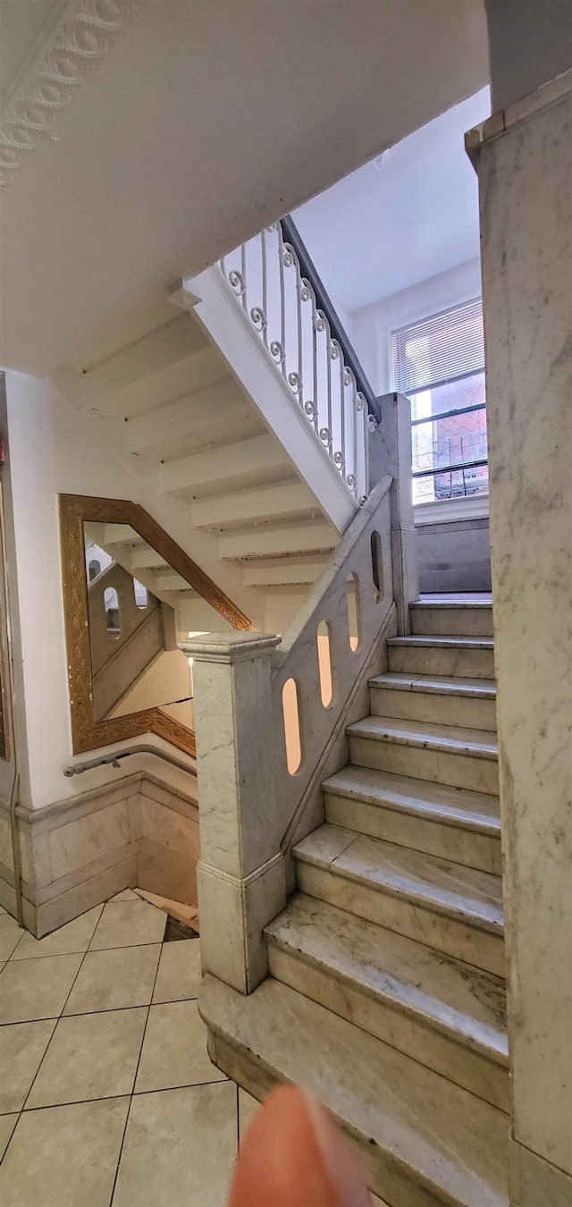 stairway with tile patterned floors