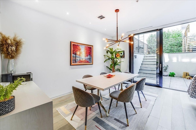 277 2nd St Unit 1, Jersey City, NJ 07302 - dining space with a chandelier, light wood-style flooring, stairway, and recessed lighting