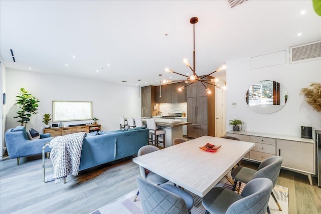 277 2nd St Unit 1, Jersey City, NJ 07302 - dining room featuring light wood-style flooring, a chandelier, and recessed lighting