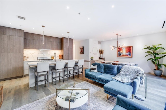 277 2nd St Unit 1, Jersey City, NJ 07302 - living room featuring light wood-style floors, recessed lighting, and a chandelier