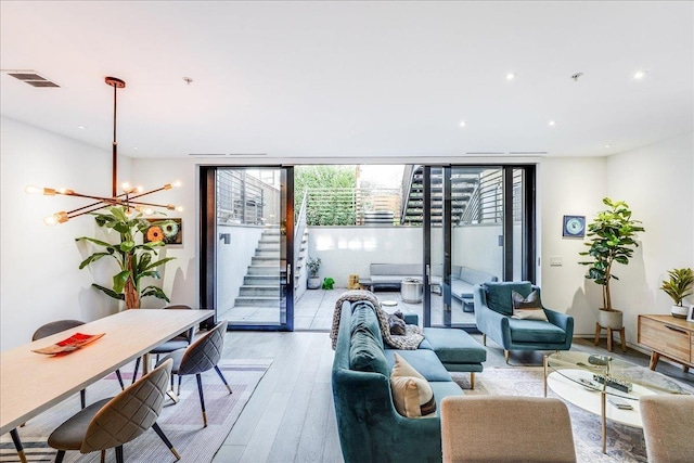 277 2nd St Unit 1, Jersey City, NJ 07302 - living room featuring a chandelier, expansive windows, stairway, light wood-style flooring, and recessed lighting