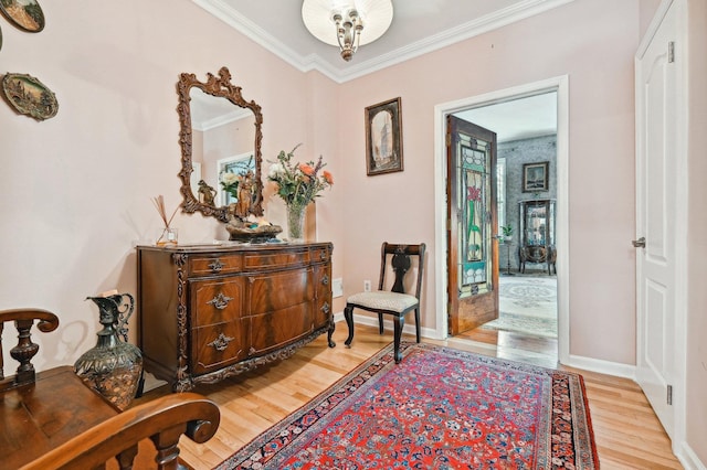 interior space with ornamental molding and light hardwood / wood-style floors