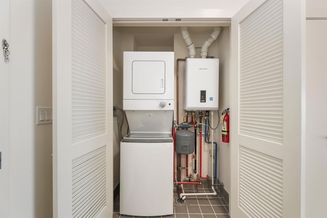 391 Palisade Ave Unit 202, Jersey City, NJ 07307 - laundry room with stacked washer / drying machine, tankless water heater, and tile patterned flooring