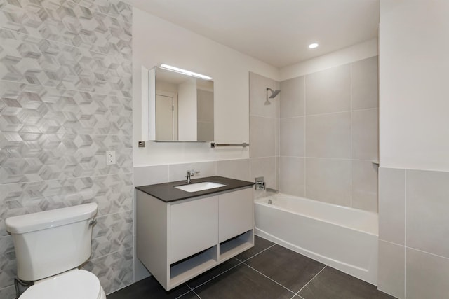 391 Palisade Ave Unit 202, Jersey City, NJ 07307 - bathroom featuring tile walls, vanity,  shower combination, and tile patterned flooring