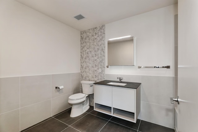 391 Palisade Ave Unit 202, Jersey City, NJ 07307 - bathroom with tile walls, vanity, tile patterned floors, and wainscoting