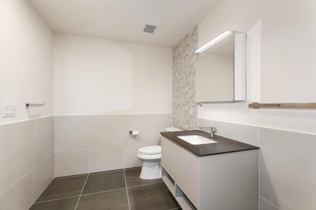 391 Palisade Ave Unit 202, Jersey City, NJ 07307 - bathroom with tile walls, vanity, tile patterned floors, and wainscoting