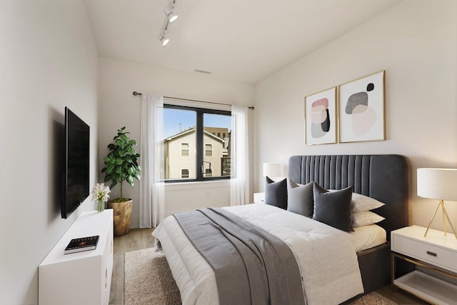 391 Palisade Ave Unit 202, Jersey City, NJ 07307 - bedroom with wood finished floors and rail lighting