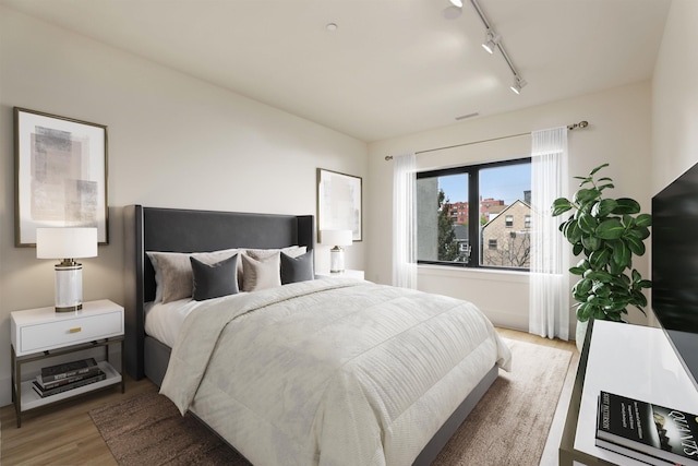 391 Palisade Ave Unit 202, Jersey City, NJ 07307 - bedroom with rail lighting and light wood-type flooring