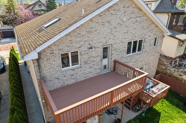 rear view of property with fence and a wooden deck