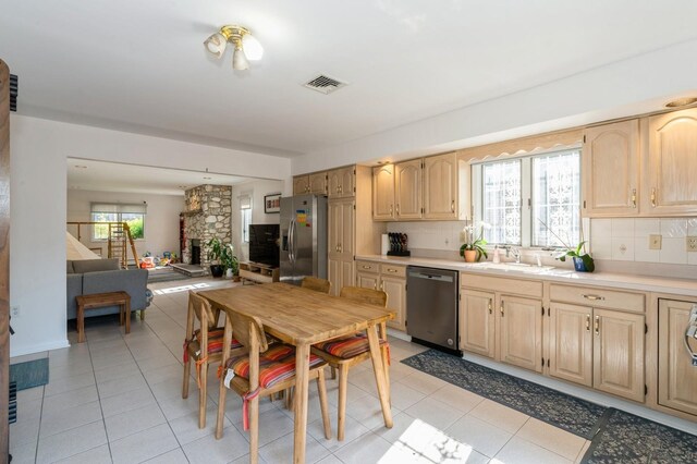 kitchen featuring visible vents, light brown cabinetry, light countertops, tasteful backsplash, and stainless steel appliances