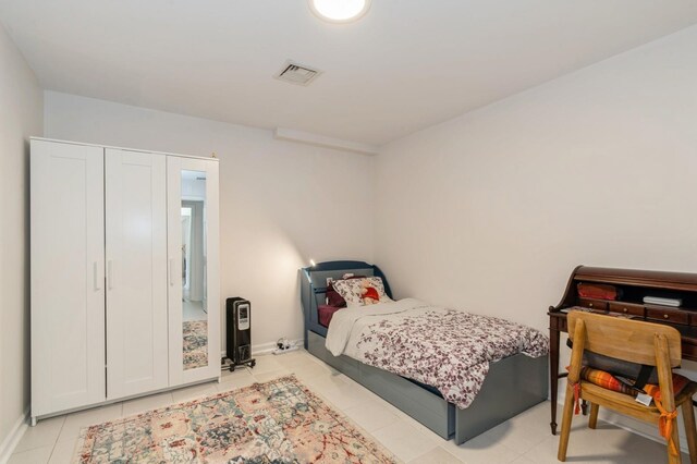 bedroom with light tile patterned flooring, baseboards, and visible vents