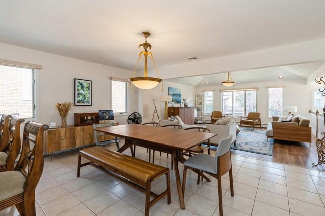 dining space with visible vents, light tile patterned floors, and a healthy amount of sunlight