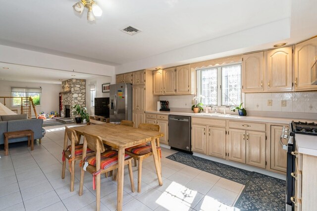 kitchen with light countertops, stainless steel appliances, visible vents, and light brown cabinets