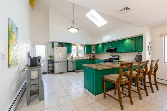 kitchen featuring visible vents, a skylight, appliances with stainless steel finishes, baseboard heating, and green cabinets