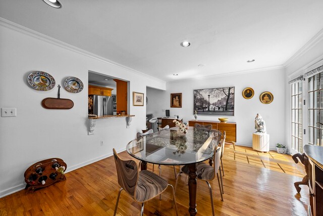 dining room with baseboards, ornamental molding, recessed lighting, and wood finished floors