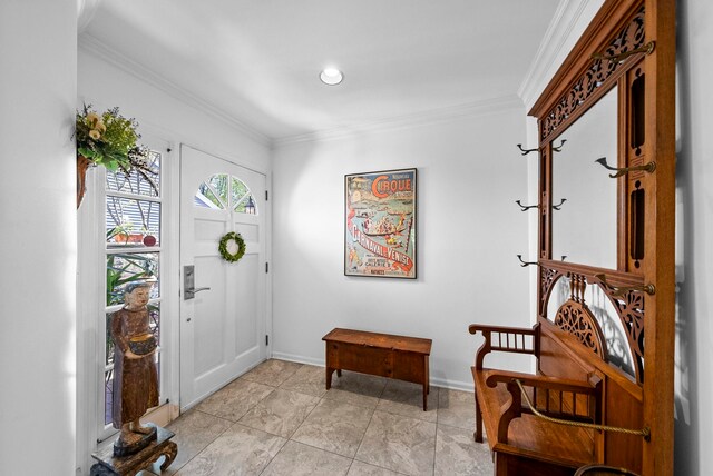 entryway with crown molding and baseboards