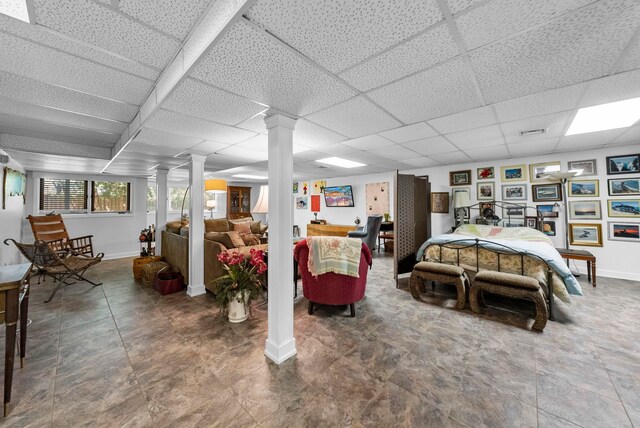 bedroom featuring baseboards, decorative columns, a paneled ceiling, and visible vents