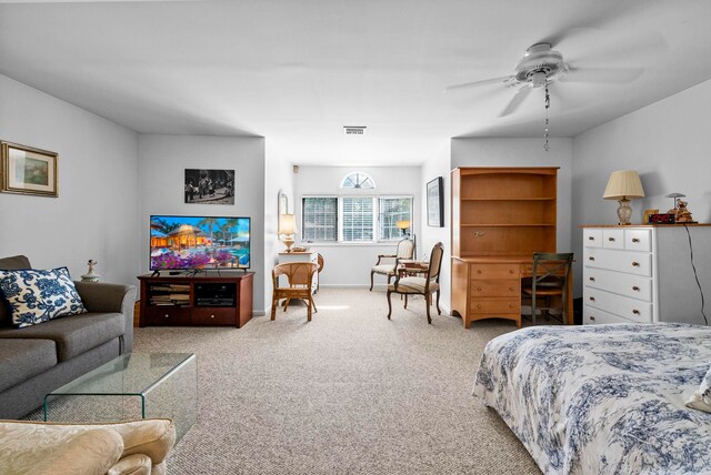 carpeted bedroom with a ceiling fan, baseboards, and visible vents