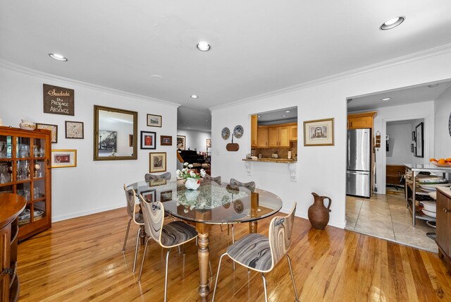 dining room with recessed lighting and ornamental molding