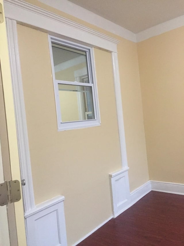 interior space with hardwood / wood-style floors and ornamental molding