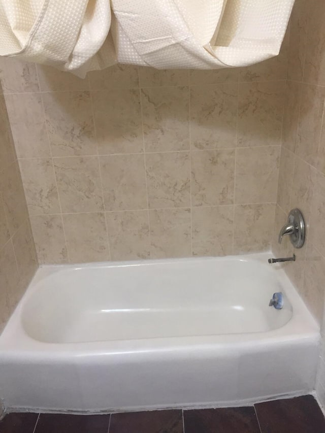 bathroom featuring tile patterned floors and a washtub