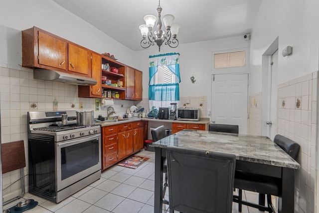 6910 Jackson St, Guttenberg, NJ 07093 - kitchen featuring stainless steel appliances, under cabinet range hood, open shelves, a chandelier, and brown cabinetry