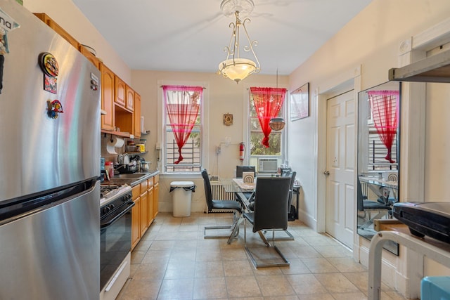 6910 Jackson St, Guttenberg, NJ 07093 - kitchen featuring freestanding refrigerator, range with gas stovetop, cooling unit, hanging light fixtures, and light tile patterned flooring
