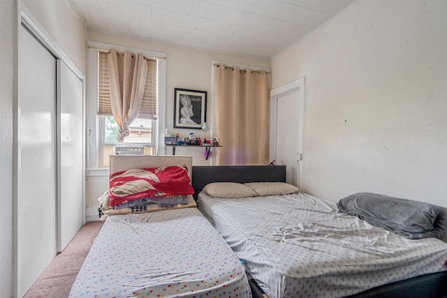 6910 Jackson St, Guttenberg, NJ 07093 - bedroom featuring light carpet, ornamental molding, and a closet