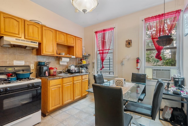 6910 Jackson St, Guttenberg, NJ 07093 - kitchen with gas range oven, under cabinet range hood, decorative backsplash, cooling unit, and dark countertops