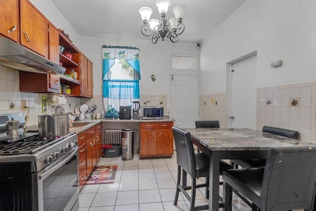 6910 Jackson St, Guttenberg, NJ 07093 - kitchen with stainless steel appliances, open shelves, under cabinet range hood, a chandelier, and decorative backsplash
