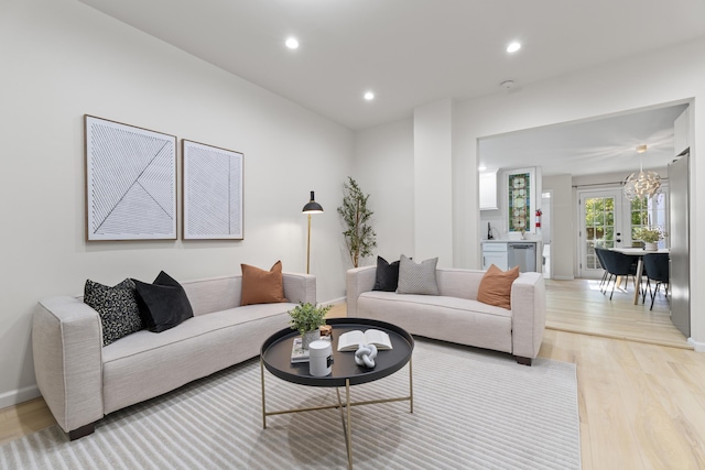 living room with light wood-style flooring, baseboards, and recessed lighting