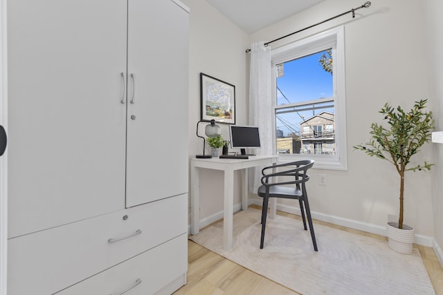 office featuring light wood-type flooring and baseboards