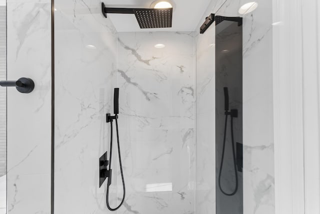 bathroom with a marble finish shower