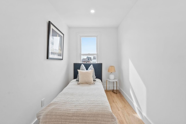 bedroom featuring light wood-type flooring, baseboards, and recessed lighting