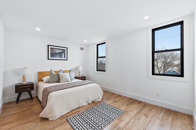 bedroom with recessed lighting, visible vents, light wood-style flooring, and baseboards