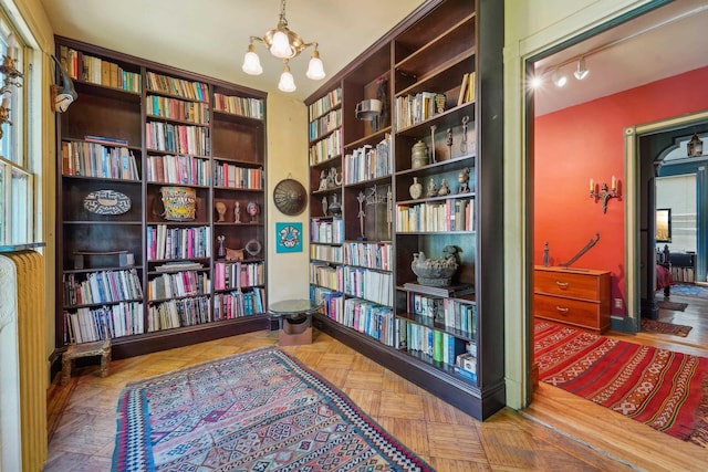 74 Sherman Pl, Jersey City, NJ 07307 - sitting room with bookshelves and a chandelier