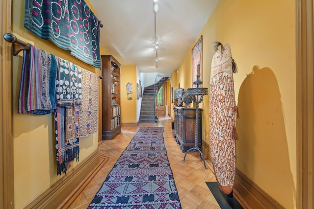 74 Sherman Pl, Jersey City, NJ 07307 - hall featuring track lighting, stairway, and baseboards
