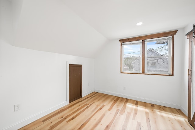 1 Sisson Ct, Bayonne, NJ 07002 - bonus room with light wood-style floors, vaulted ceiling, baseboards, a barn door, and recessed lighting