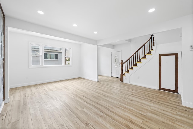 1 Sisson Ct, Bayonne, NJ 07002 - unfurnished living room featuring stairway, light wood-type flooring, baseboards, and recessed lighting