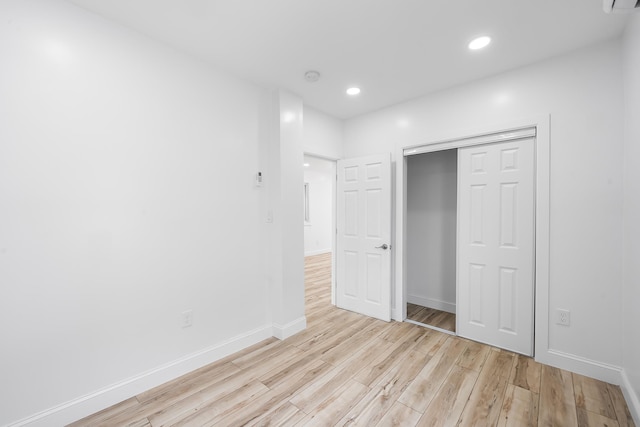 1 Sisson Ct, Bayonne, NJ 07002 - unfurnished bedroom with light wood-type flooring, baseboards, recessed lighting, and a closet